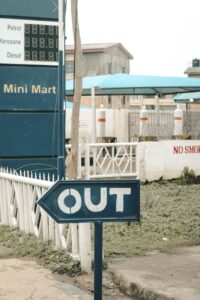 white and blue text sign on the street